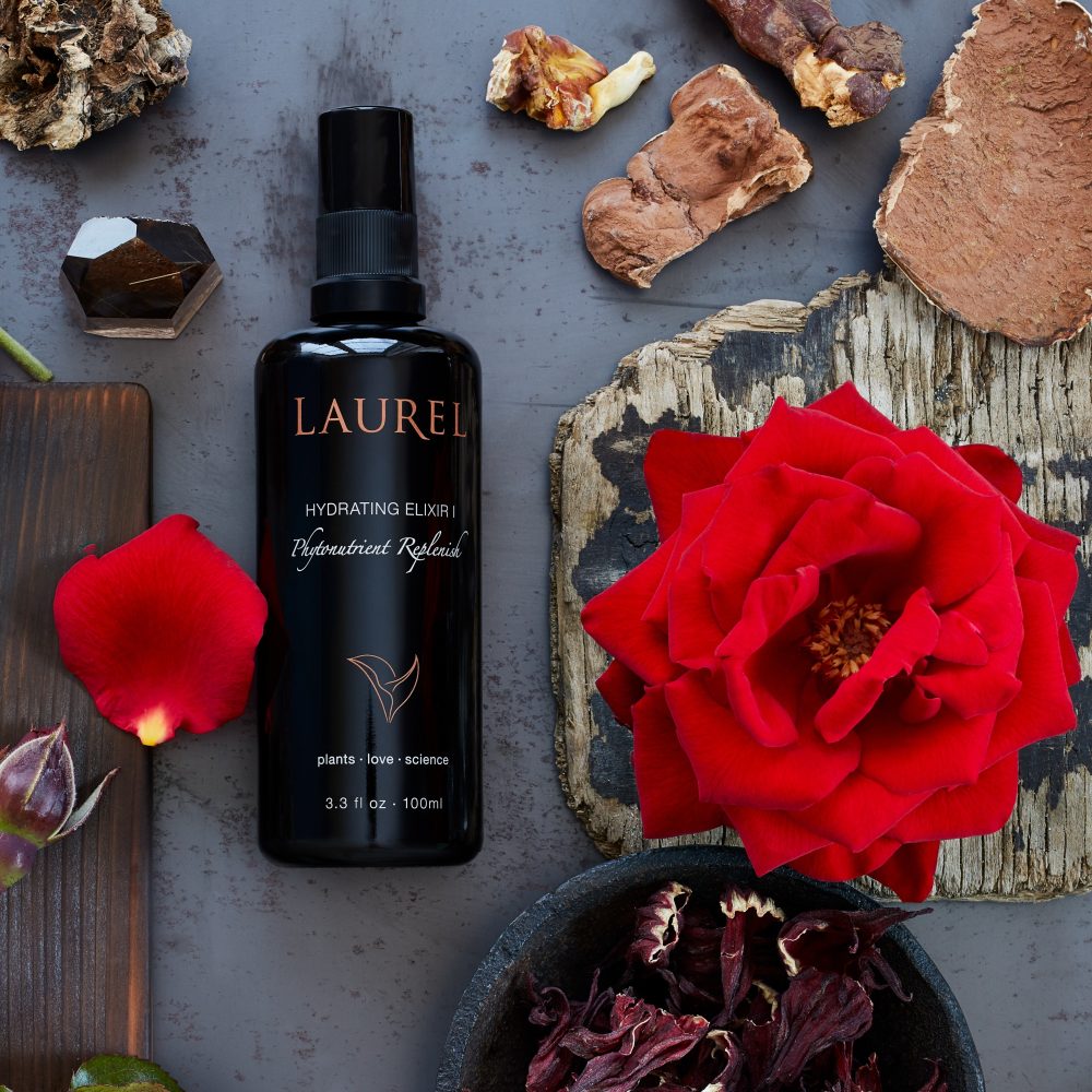 Hydrating Elixir I surrounded by rich red petals and mushrooms.